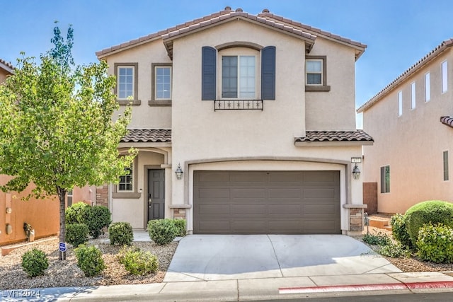 mediterranean / spanish-style home with a garage