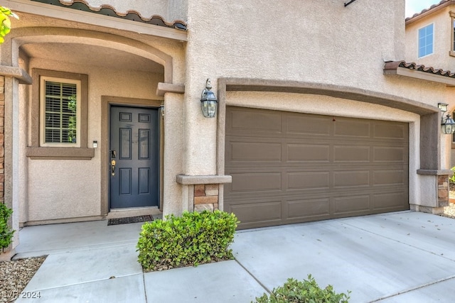 view of exterior entry featuring a garage