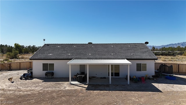 back of house with a patio and a mountain view