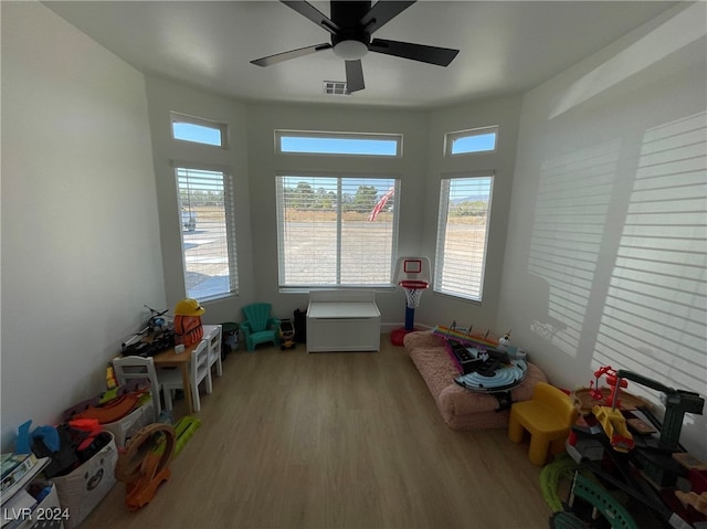 game room with light wood-type flooring and ceiling fan