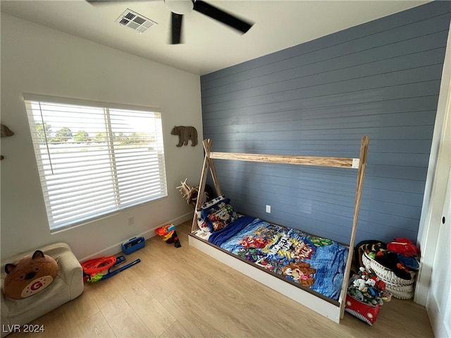 bedroom with wood-type flooring and ceiling fan