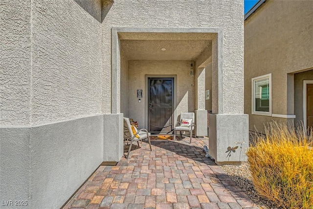 entrance to property featuring a patio area