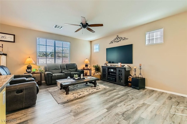 living room featuring light hardwood / wood-style floors and ceiling fan