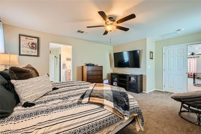 bedroom featuring ceiling fan, ensuite bath, and light carpet