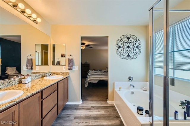 bathroom with ceiling fan, wood-type flooring, separate shower and tub, and vanity