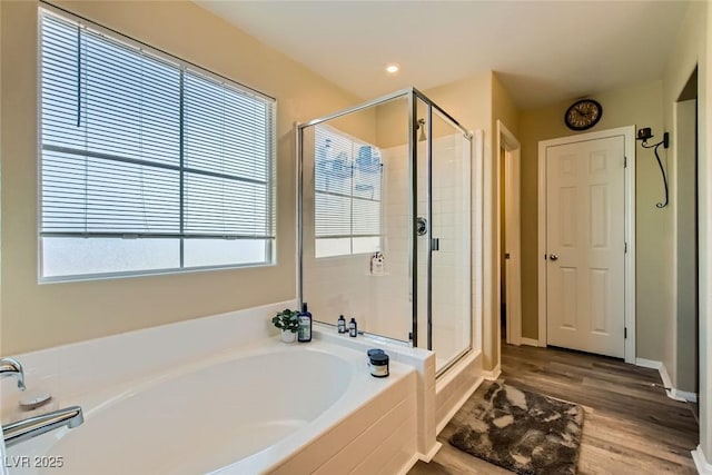 bathroom featuring independent shower and bath and hardwood / wood-style floors