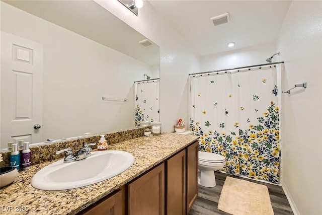 bathroom with hardwood / wood-style flooring, vanity, toilet, and a shower with curtain