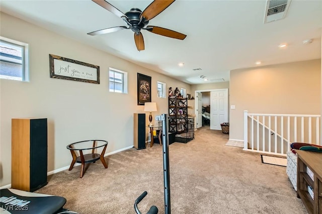 interior space featuring light colored carpet and a healthy amount of sunlight