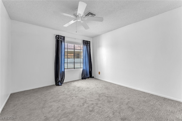 empty room with a textured ceiling, ceiling fan, and carpet floors