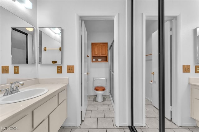 bathroom featuring vanity, toilet, and tile patterned floors