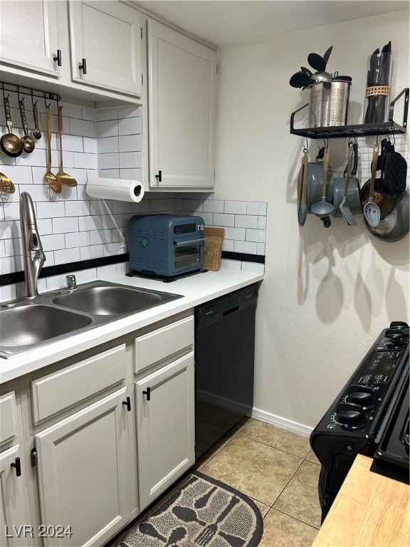 kitchen featuring black appliances, white cabinets, light tile patterned floors, and tasteful backsplash