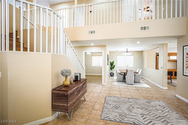 tiled living room with a high ceiling