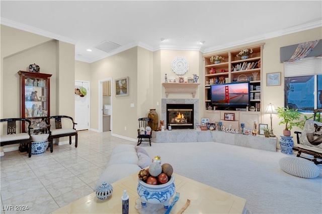 living room with a fireplace, crown molding, and built in shelves