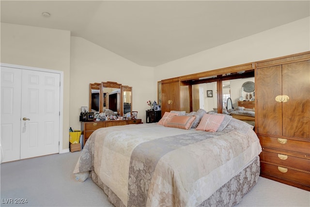 bedroom featuring vaulted ceiling and light colored carpet