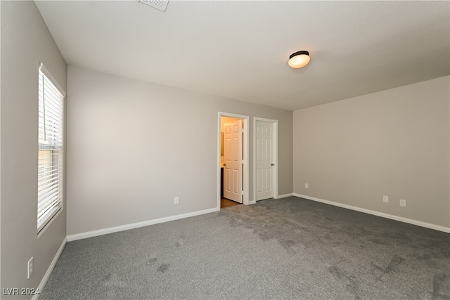 unfurnished bedroom featuring dark colored carpet