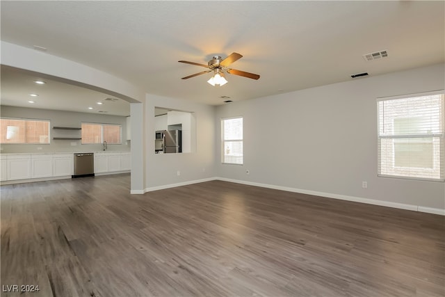 unfurnished living room featuring ceiling fan, dark hardwood / wood-style floors, and sink