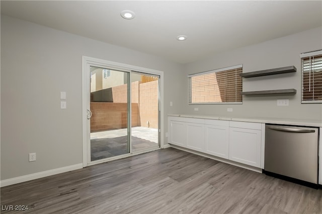 kitchen featuring light wood-type flooring, white cabinetry, and stainless steel dishwasher