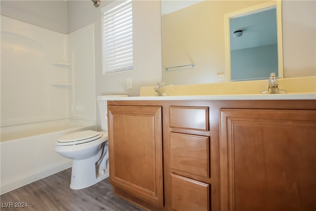 full bathroom featuring vanity, toilet, hardwood / wood-style flooring, and bathing tub / shower combination