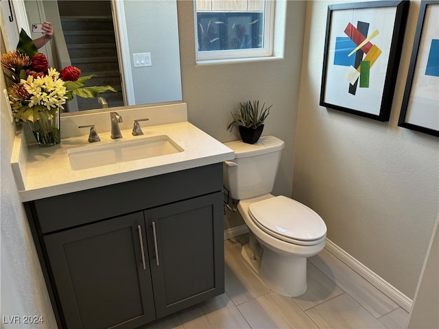 bathroom with vanity, tile patterned flooring, and toilet