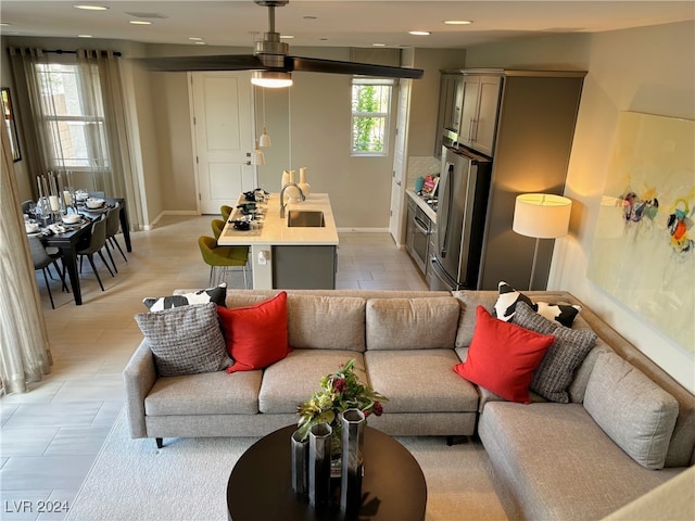 living room featuring ceiling fan and sink