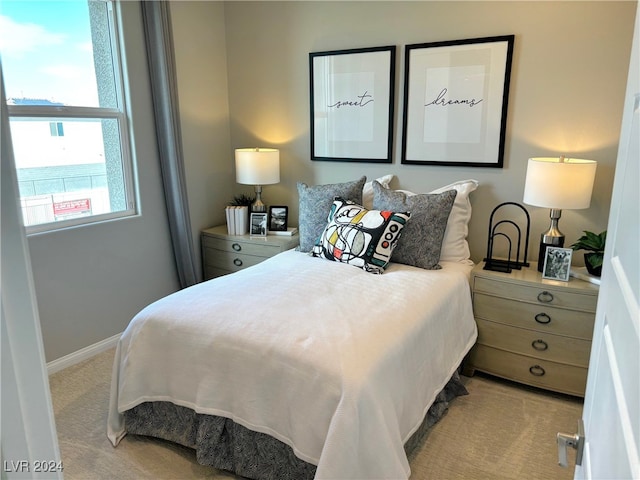 bedroom featuring light carpet