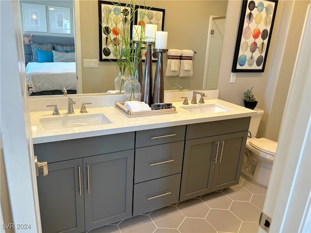 bathroom with vanity, toilet, and tile patterned floors