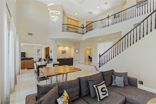 living room featuring a high ceiling and light tile patterned flooring