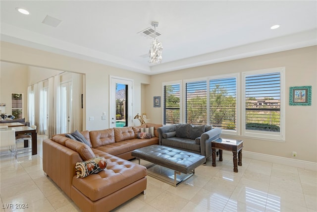 living room with light tile patterned flooring and a chandelier