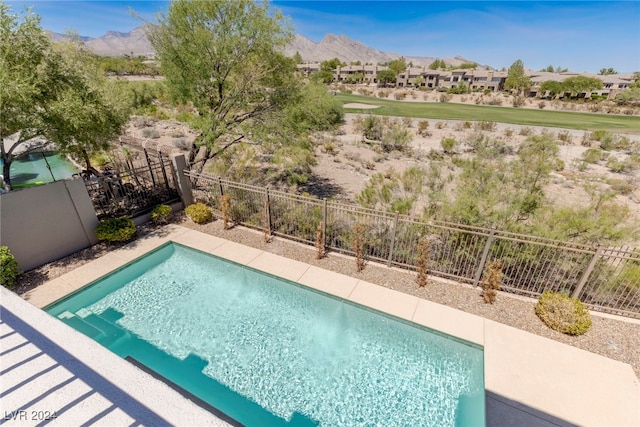 view of swimming pool featuring a mountain view