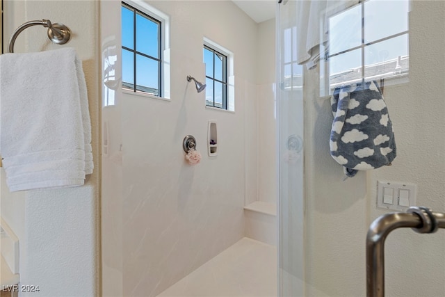 bathroom featuring a shower with door