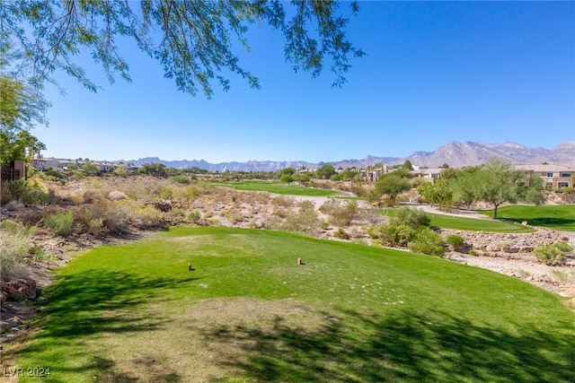 exterior space with a yard and a mountain view