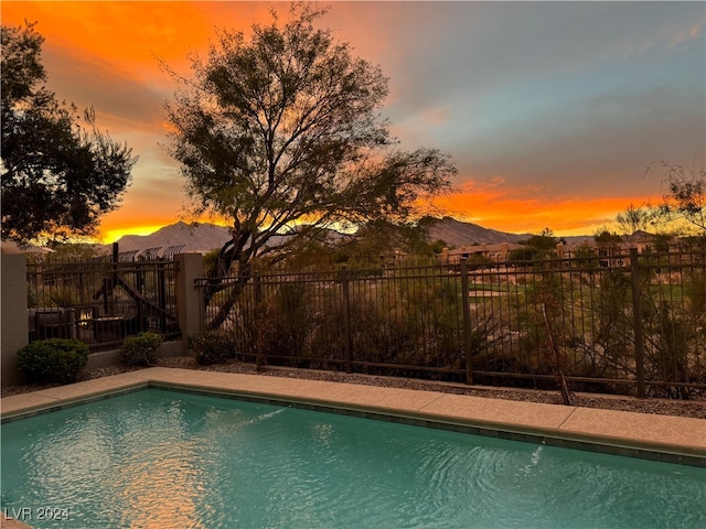 view of pool at dusk