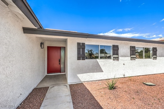 entrance to property featuring a patio