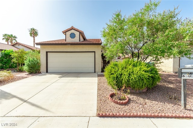 mediterranean / spanish-style home featuring a garage