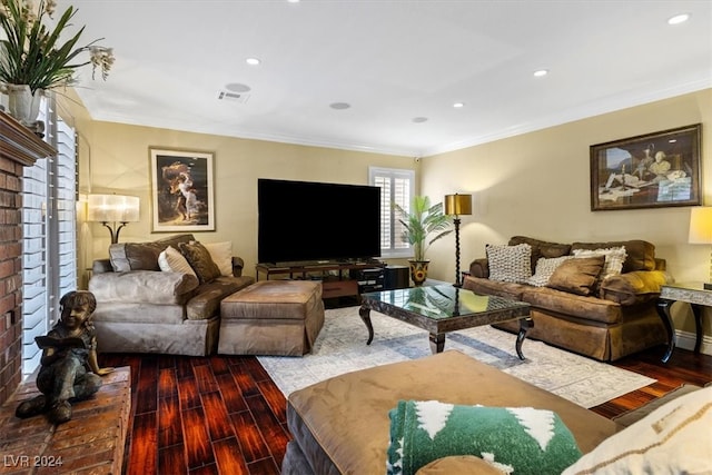 living room with hardwood / wood-style floors, a fireplace, and ornamental molding