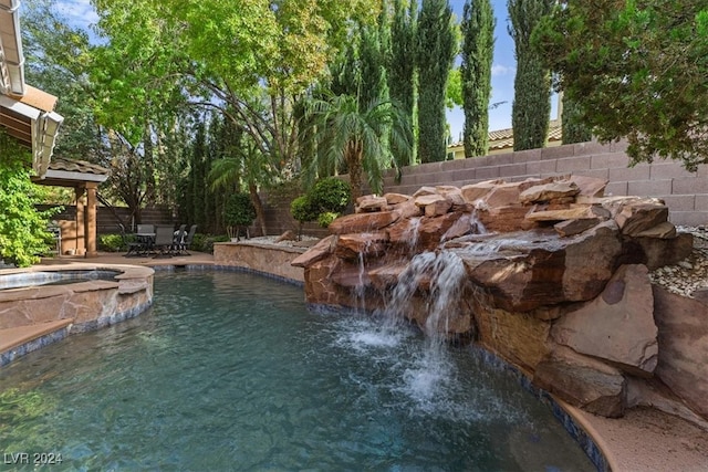 view of swimming pool featuring a patio area and an in ground hot tub