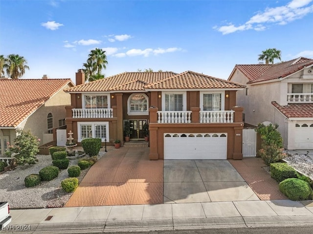 mediterranean / spanish home featuring a balcony and a garage