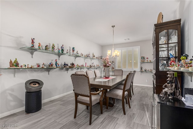 dining space featuring an inviting chandelier and light hardwood / wood-style flooring