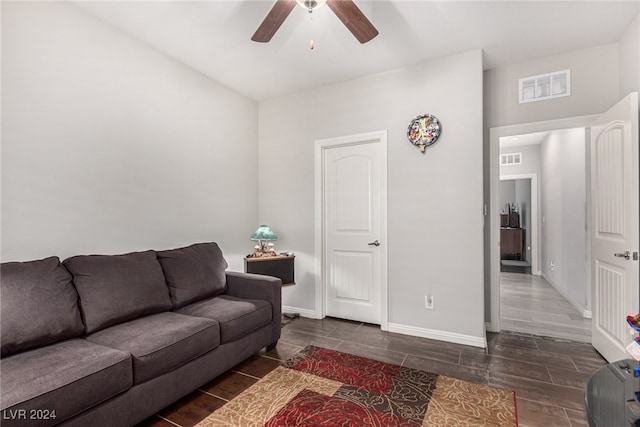 living room with ceiling fan and dark hardwood / wood-style floors