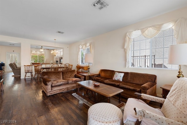 living room featuring dark hardwood / wood-style floors and an inviting chandelier