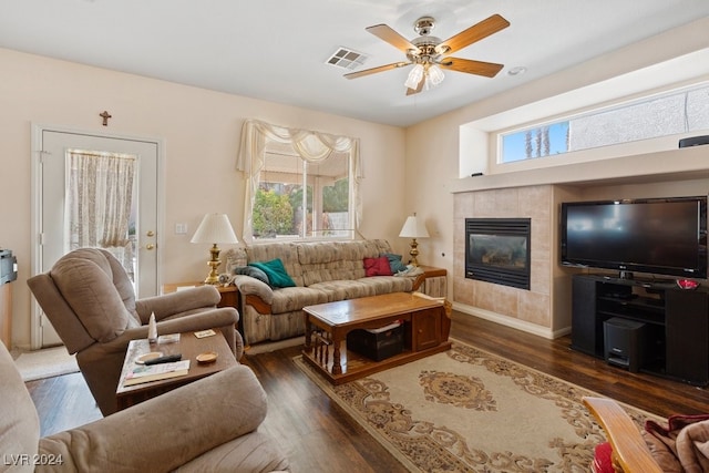 living room featuring a fireplace, dark hardwood / wood-style flooring, and ceiling fan