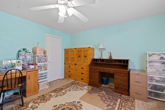 carpeted home office with ceiling fan