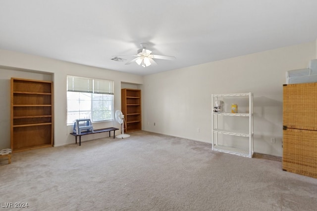 interior space with carpet flooring and ceiling fan