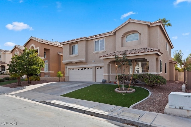 mediterranean / spanish-style home featuring a garage and a front lawn