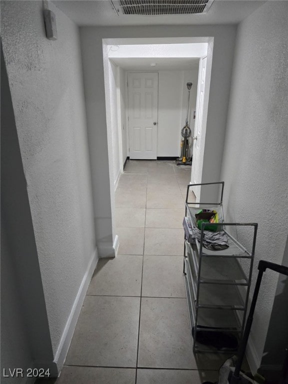 hall with light tile patterned flooring