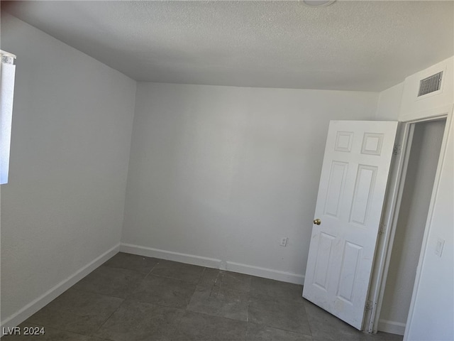 empty room with a textured ceiling