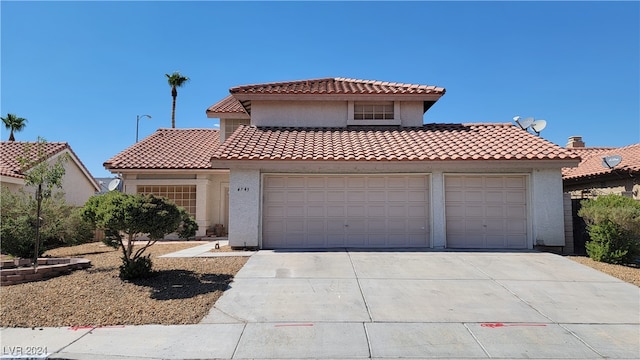 mediterranean / spanish-style house with a garage