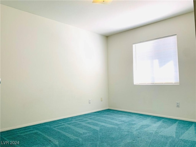 unfurnished room with baseboards and carpet floors
