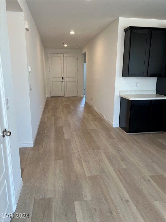 corridor with light hardwood / wood-style flooring