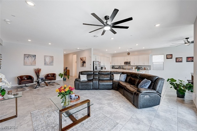 tiled living room with ceiling fan